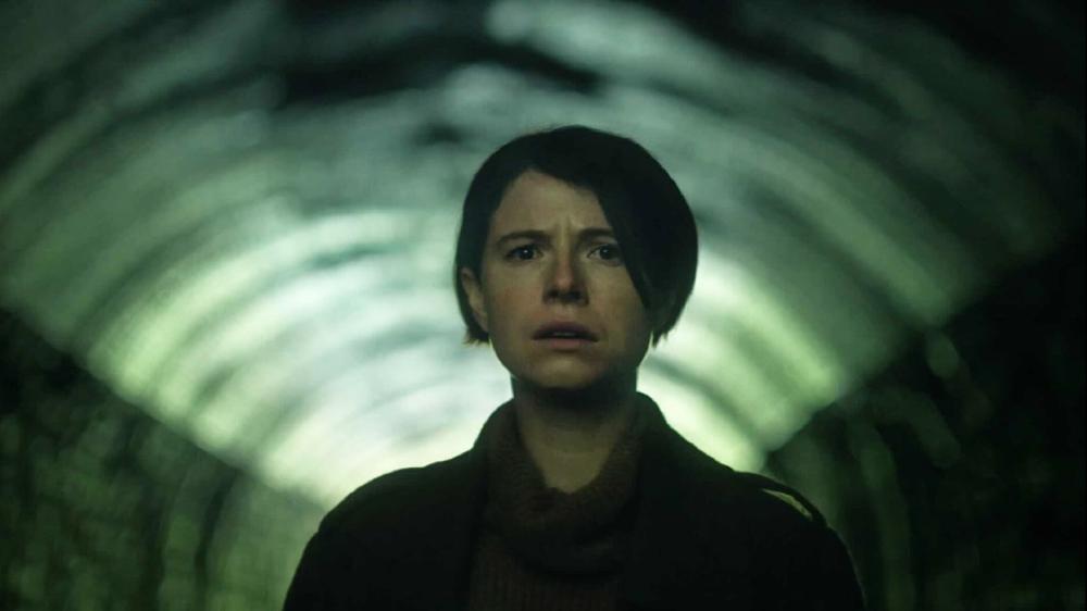 An image from the film Men of Harper, looking scared, in a tunnel.