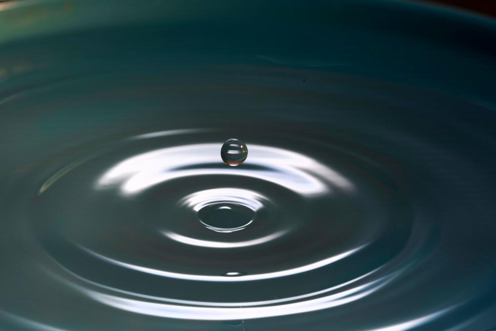 An image a ripple created by a drop of water.