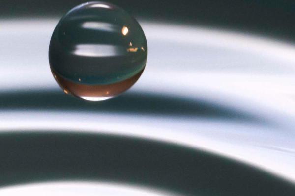 An image a ripple created by a drop of water.